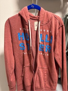 Hollister Men's Coral Zip-Up Sweatshirt with Bright Blue Logo